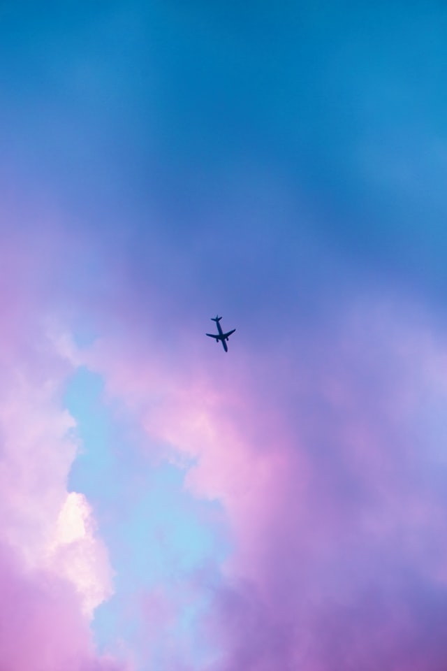 a large airplane flying high up in the air